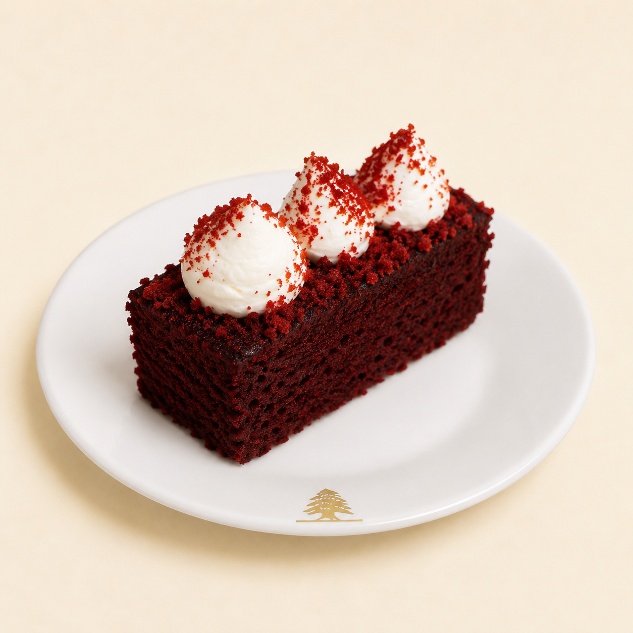 Slice of red velvet cake with cream frosting